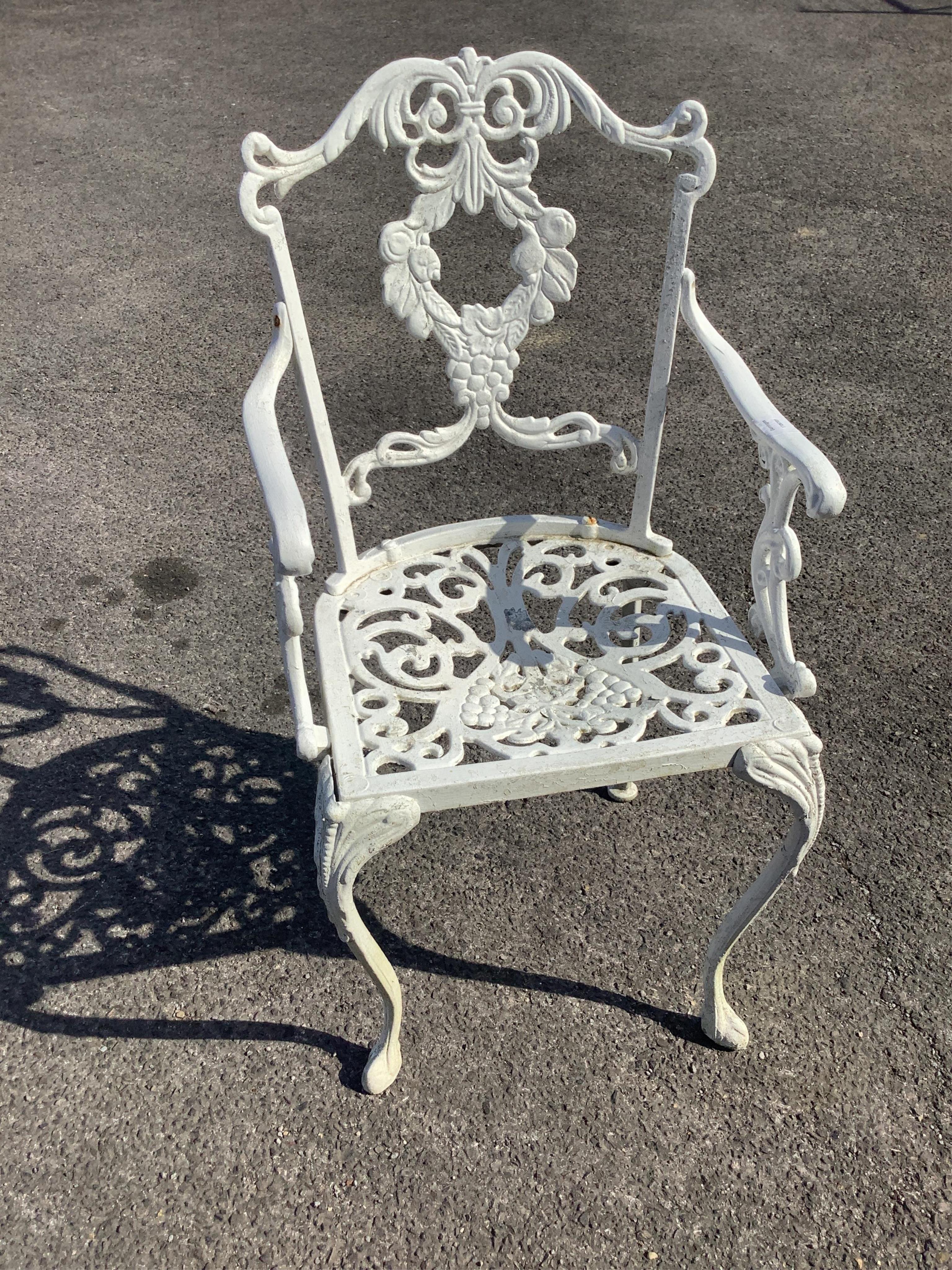 A Victorian style white painted circular aluminium garden table, diameter 90cm, height 72cm and six matching elbow chairs